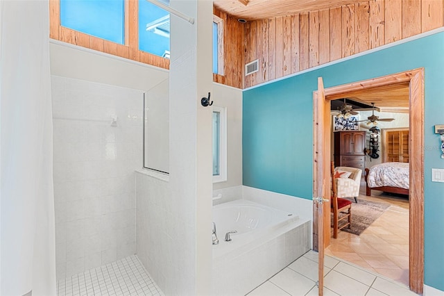 bathroom with tile patterned flooring, separate shower and tub, a towering ceiling, and ceiling fan