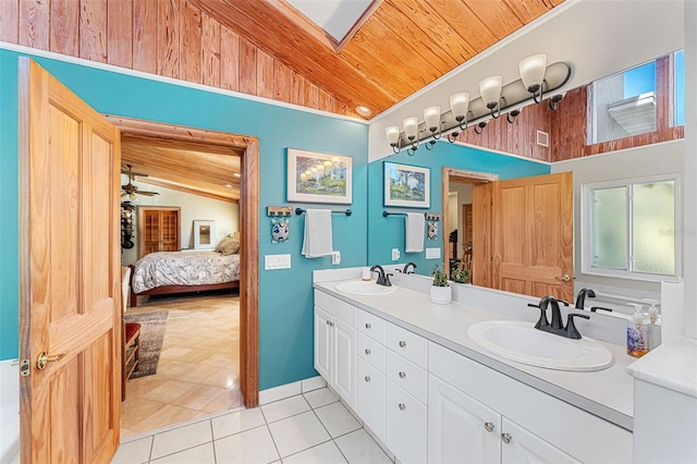 bathroom with tile patterned flooring, vanity, vaulted ceiling with skylight, and wood ceiling