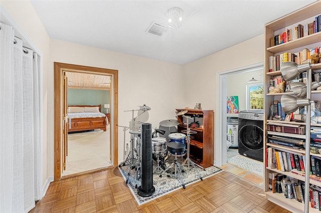 home office featuring light parquet flooring and washer / clothes dryer