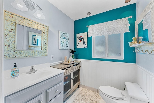 bathroom featuring tile patterned flooring, vanity, and toilet