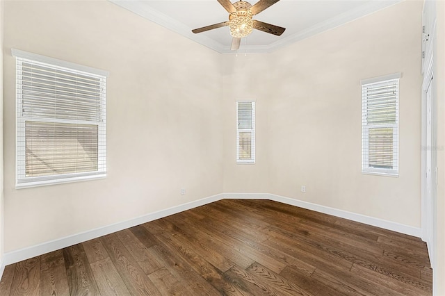 empty room featuring crown molding, ceiling fan, a wealth of natural light, and hardwood / wood-style flooring