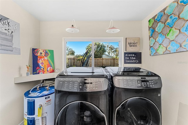 washroom with electric water heater and washer and dryer