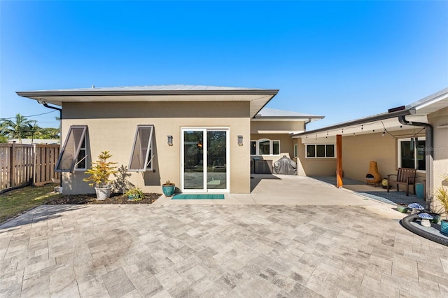 rear view of property featuring a patio area