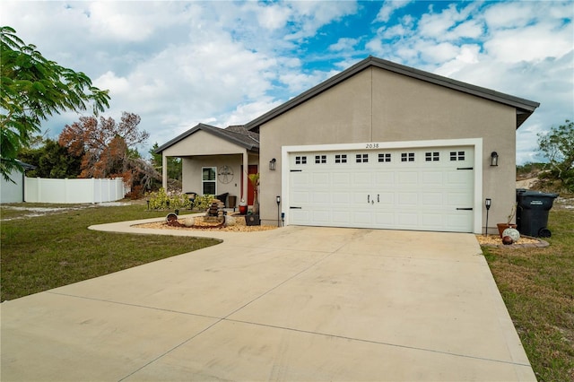 view of front of home featuring a garage and a front yard