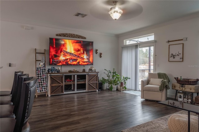 interior space featuring crown molding, dark wood-type flooring, and ceiling fan