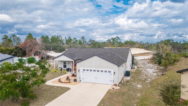 ranch-style house with central AC unit and a garage