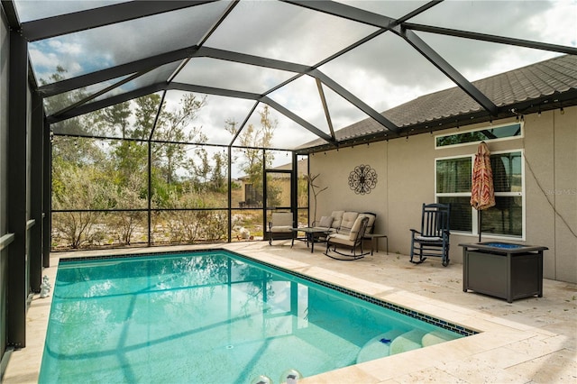 view of swimming pool featuring an outdoor living space, a patio area, and glass enclosure