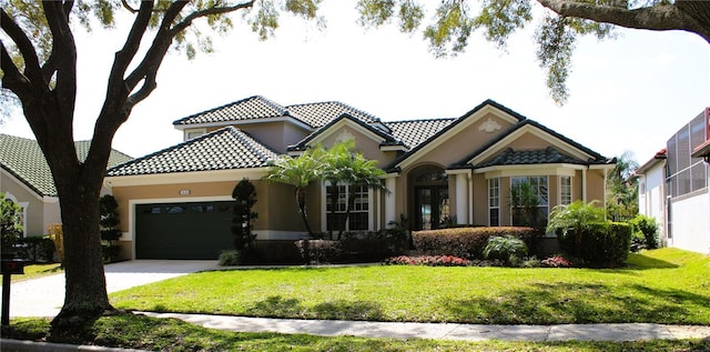 mediterranean / spanish-style house with a garage and a front yard