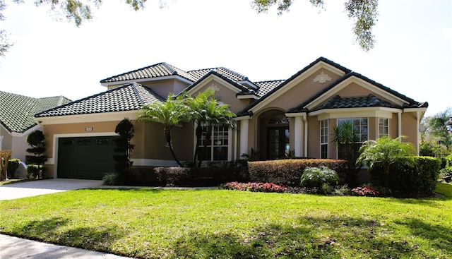 mediterranean / spanish-style home with a garage and a front yard