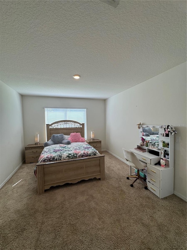 carpeted bedroom featuring a textured ceiling