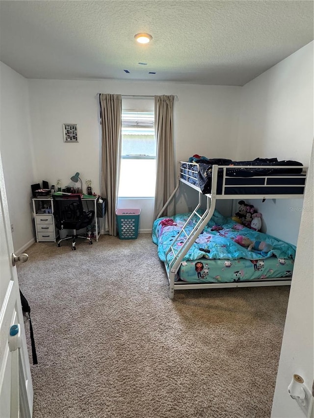 carpeted bedroom with a textured ceiling