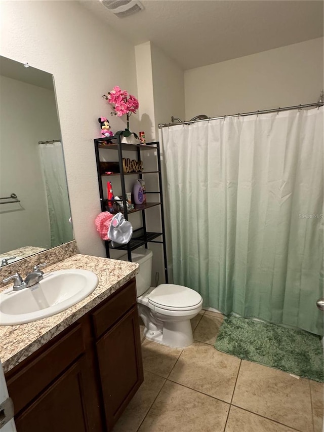 bathroom with vanity, tile patterned floors, and toilet