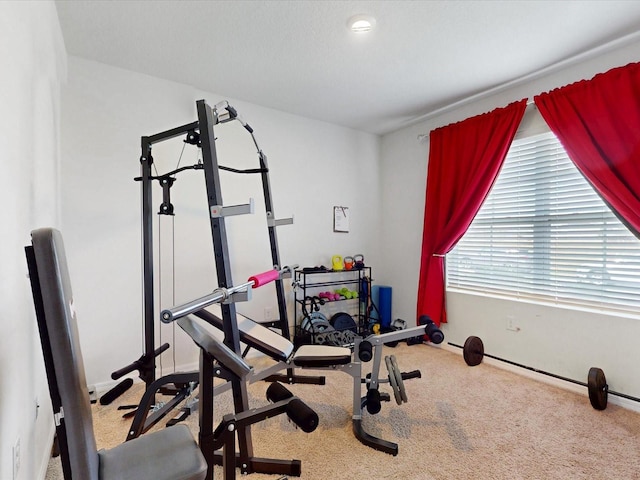 workout room with baseboards and carpet flooring