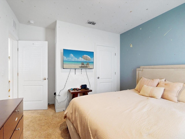 bedroom featuring light carpet and visible vents