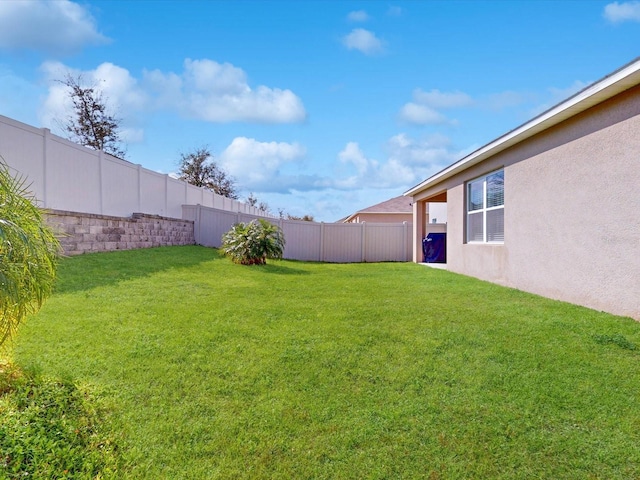 view of yard with a fenced backyard