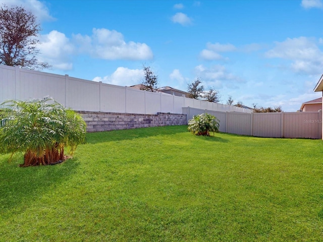 view of yard with a fenced backyard