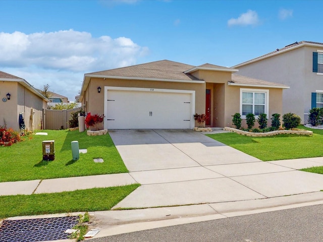 view of front of home featuring a front yard, fence, an attached garage, and stucco siding