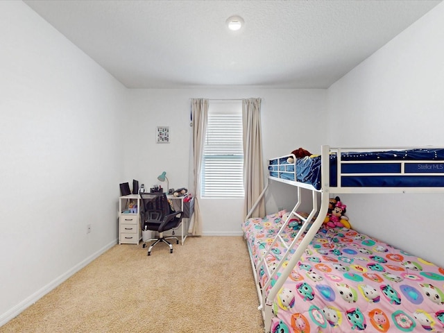 bedroom with light carpet, a textured ceiling, and baseboards