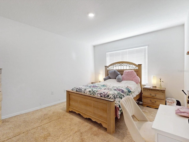 bedroom featuring baseboards and light colored carpet