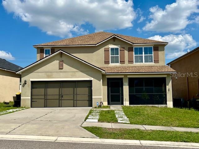 view of front of home with a garage and a front lawn