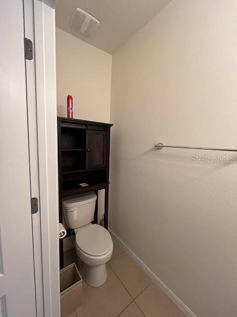 bathroom with tile patterned flooring and toilet