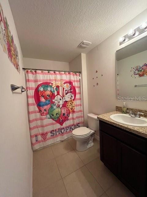 bathroom featuring tile patterned floors, toilet, a textured ceiling, vanity, and a shower with shower curtain