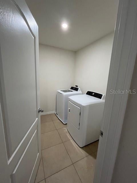 washroom featuring separate washer and dryer and light tile patterned floors