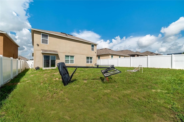 rear view of house with a yard