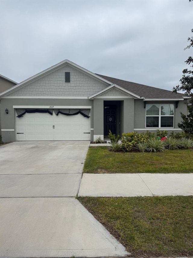 ranch-style house featuring a garage and a front lawn