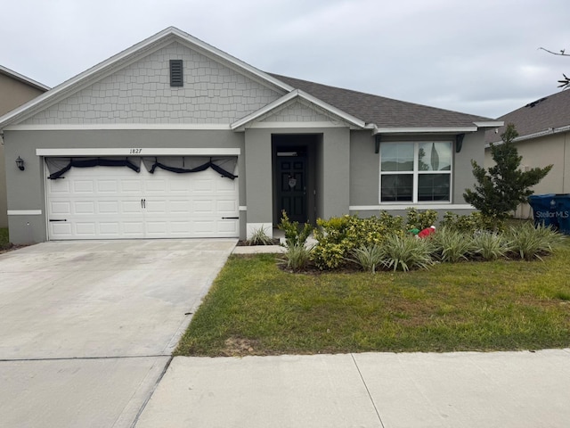 view of front of house with a garage and a front lawn