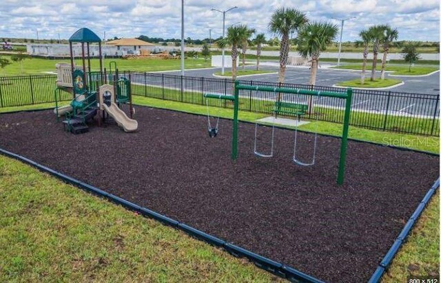 view of jungle gym with a lawn