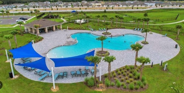 view of pool with a patio area and a lawn