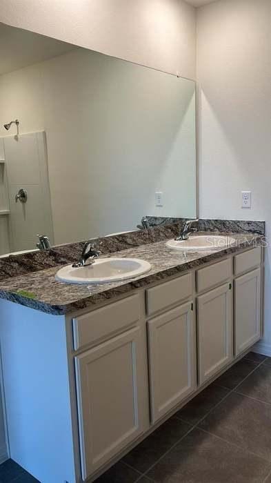 1827 Silverbell Loop, Haines City, FL 33844 - full bathroom with double vanity and tile patterned floors