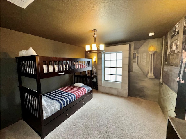 bedroom with carpet floors and a textured ceiling