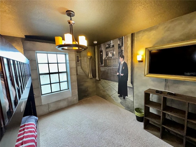 carpeted living room with a chandelier and a textured ceiling