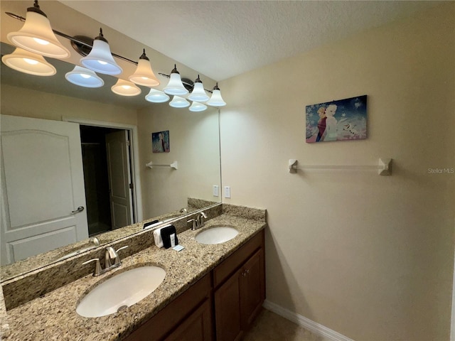 bathroom with vanity and a textured ceiling