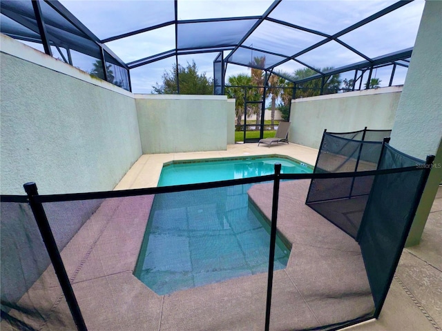 view of swimming pool with a patio and glass enclosure