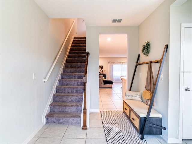 staircase with tile patterned floors