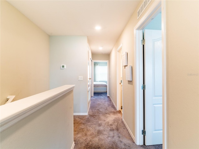 corridor with light colored carpet