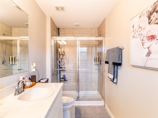 bathroom featuring vanity, toilet, and walk in shower