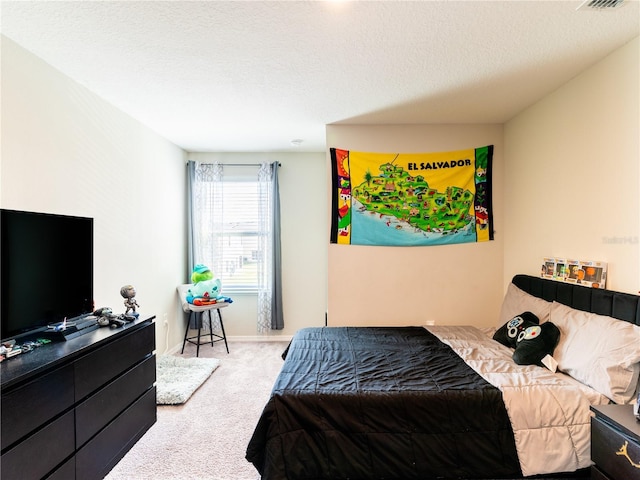 bedroom featuring light carpet and a textured ceiling