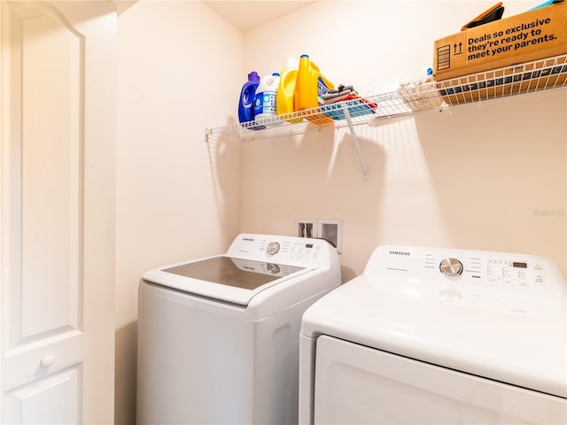 clothes washing area featuring washer and dryer