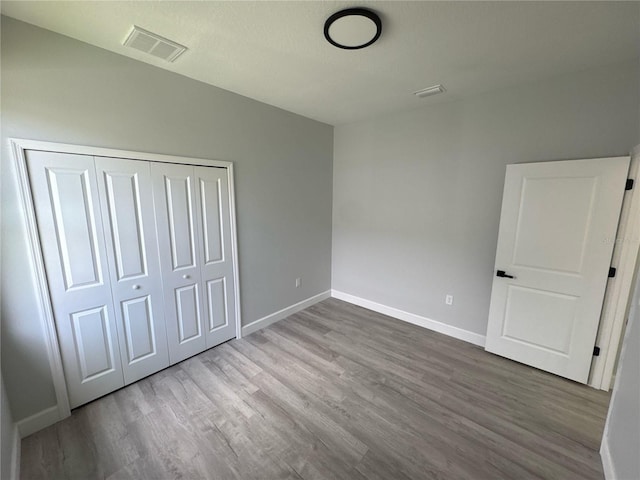 104 Australian Dr, Rotonda West, FL 33947 - unfurnished bedroom with wood finished floors and a closet