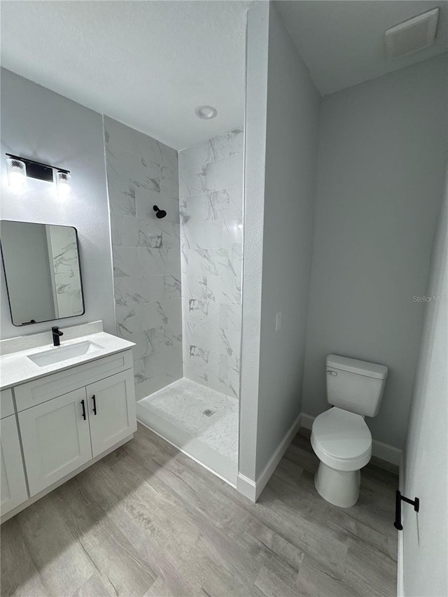 104 Australian Dr, Rotonda West, FL 33947 - full bath with wood finished floors, vanity, and a marble finish shower