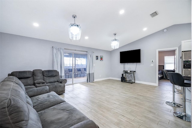 living room with lofted ceiling and light wood-type flooring