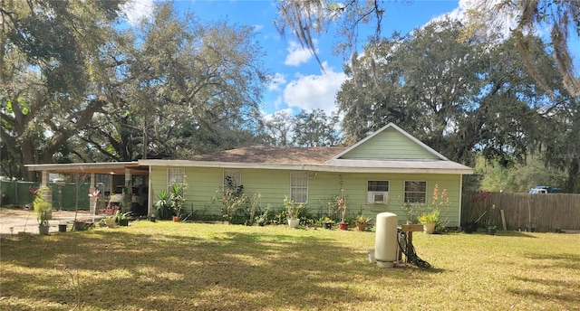 rear view of property with a yard