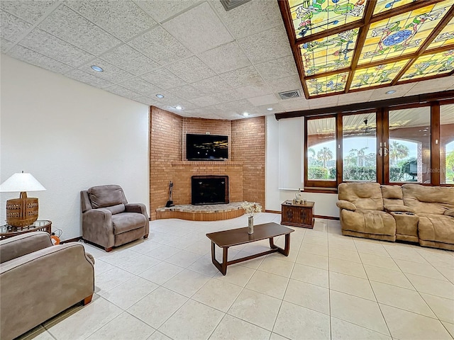 tiled living room with a brick fireplace