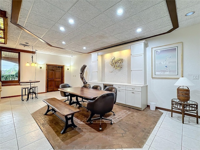 home office featuring light tile patterned flooring and a drop ceiling