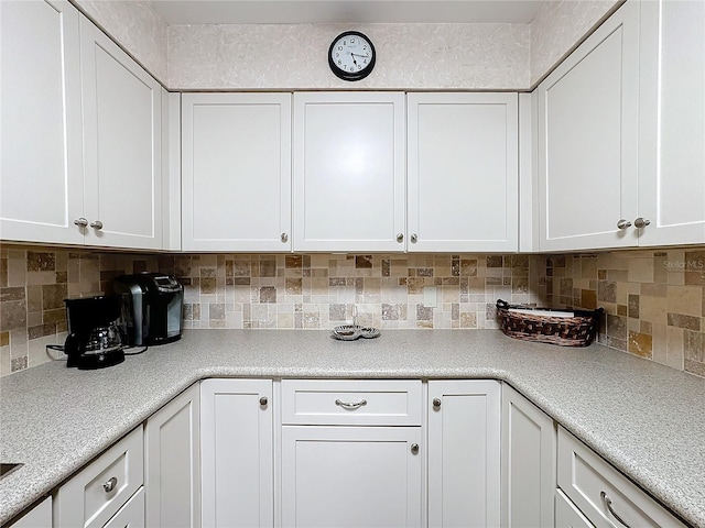 kitchen with white cabinetry and decorative backsplash