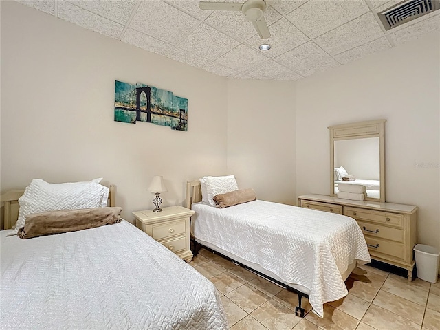 bedroom with a paneled ceiling and ceiling fan